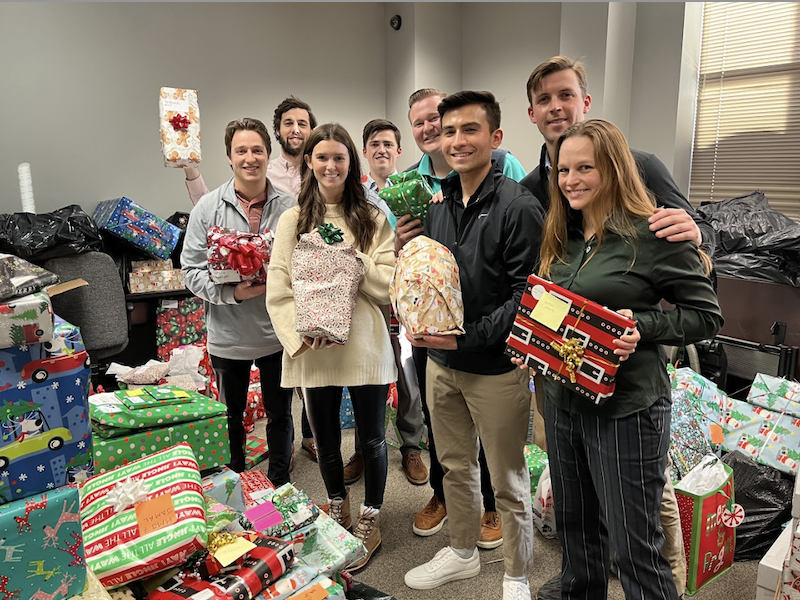 group of VOA volunteers holding presents